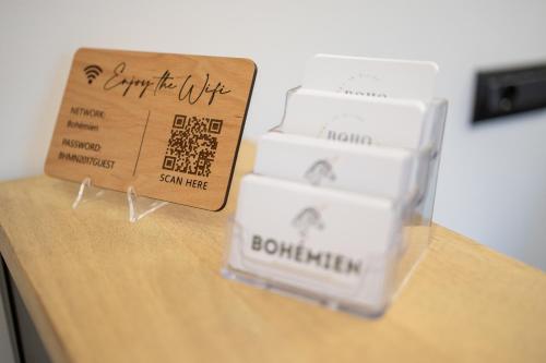 a stack of plastic containers on a table with a box at Bohémien Boutique Guesthouse in Cefalù