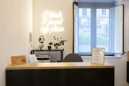 a desk with a sign that says just send my phone at Bohémien Boutique Guesthouse in Cefalù