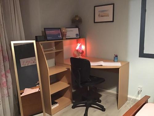 an office with a desk with a chair and a mirror at L’orée des fleurs in Rochechouart