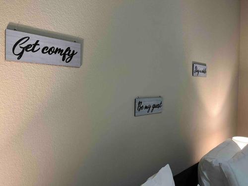 a room with signs on the wall of a bedroom at Hill Country Hiatus! in Austin