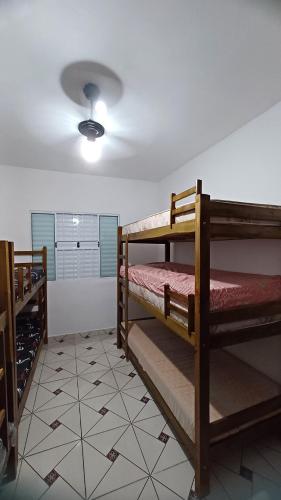 a room with two bunk beds and a ceiling at Balneário Jussara in Mongaguá