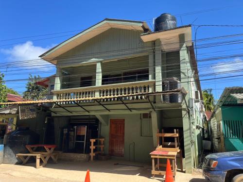 a house with a balcony on top of it at Hotel Gusto Bueno in Coxen Hole