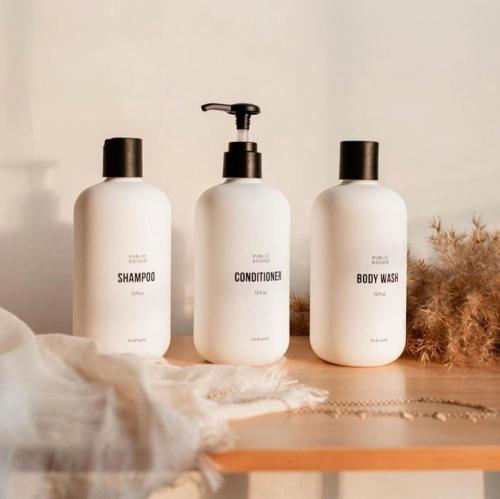 three bottles of shampoo and conditioner sitting on a table at Modern A-Frame - Mountain Views - Evergreen in Evergreen
