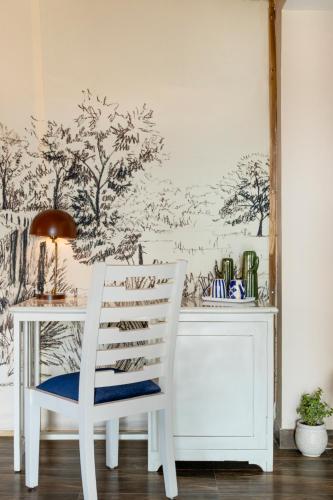 a white desk with a chair in a room at Sterling ReWild Sariska in Tehla