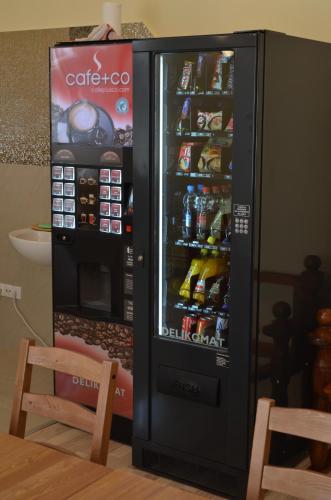 a large black refrigerator with drinks in it at Hostel Sonce in Ptuj