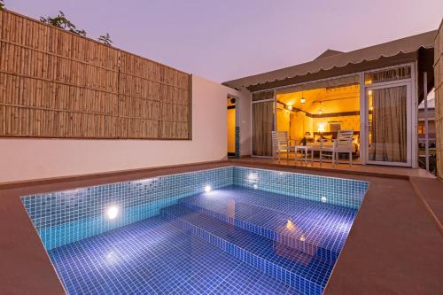 a swimming pool in the backyard of a house at Sterling ReWild Sariska in Tehla