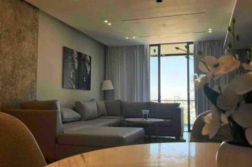 a living room with a couch and a table at Luxury 2-bedroom Apartment Abdoun tower in Amman
