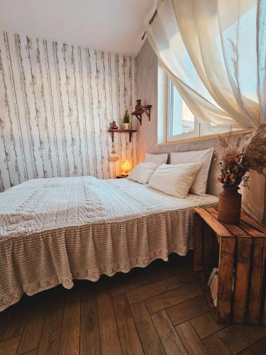 a bedroom with a bed and a window at Lawendowy Raj in Pilchowice