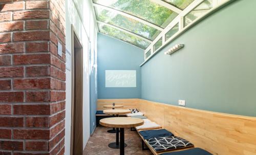 a room with a table and a brick wall at Safestay Bratislava Presidential Palace in Bratislava