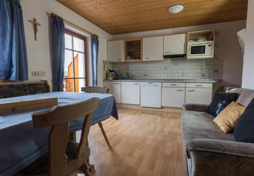 a kitchen and living room with a table and a couch at Zehentnerhof in Laion