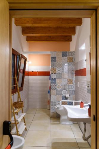 a bathroom with two sinks and a toilet at Agriturismo La Ferrovia in Molfetta