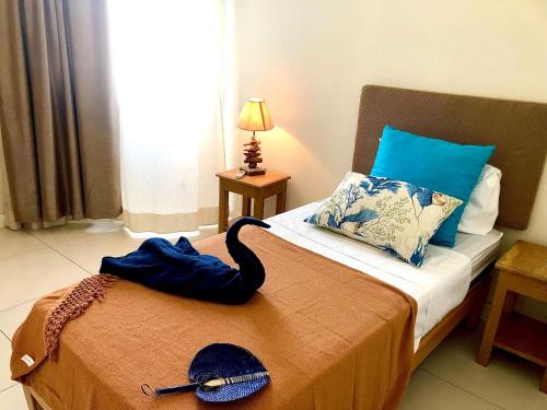 a room with a bed with a black swan on it at Blue Lagoon seafront apartment in Flic-en-Flac