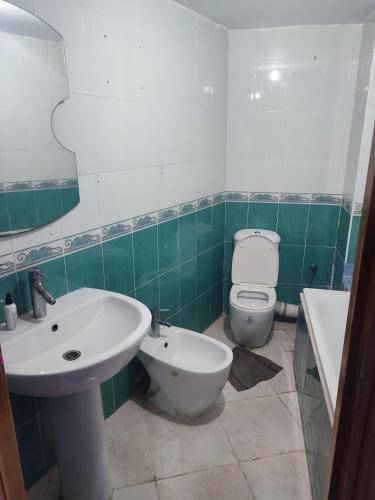 a bathroom with a white sink and a toilet at la tulipe in Tangier