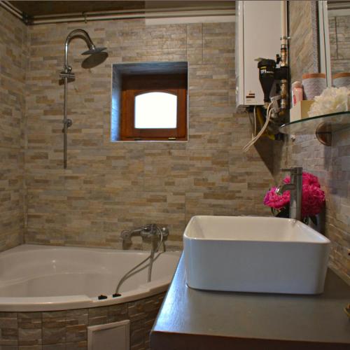 a bathroom with a tub and a sink at Bogáncs Vendégház - Nagybörzsöny in Nagybörzsöny