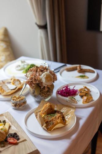 a table with several plates of food on it at Hotel Mrak in Ljubljana