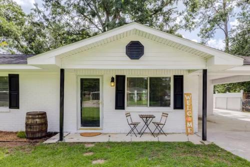 a white house with two chairs and a table at The Peach Family Friendly Oasis in Savannah