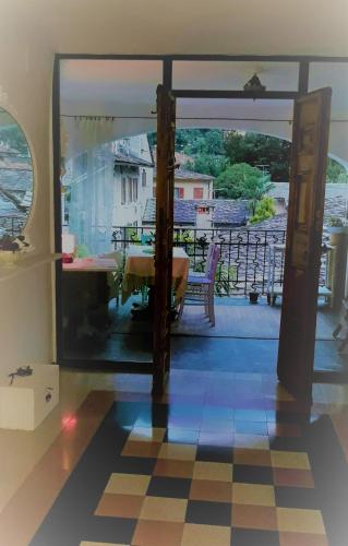 a room with a view of a balcony with a table at bb chiavenna centro storico in Chiavenna