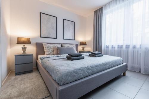 a bedroom with a large bed with two pillows on it at Apartment Schwarzwald Panorama in Baden-Baden