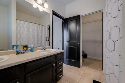 a bathroom with a sink and a large mirror at Honey, I’m Home near Savannah - Seen on HGTV in Savannah
