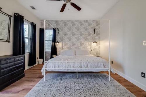 a bedroom with a bed and a ceiling fan at Honey, I’m Home near Savannah - Seen on HGTV in Savannah