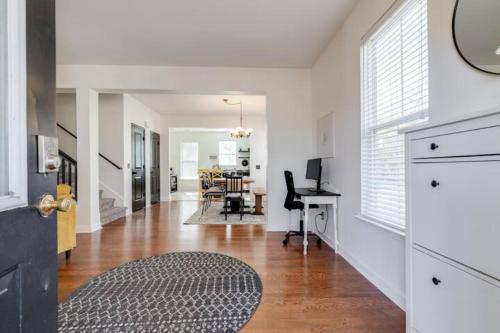 a living room with white walls and a hard wood floor at Honey, I’m Home near Savannah - Seen on HGTV in Savannah