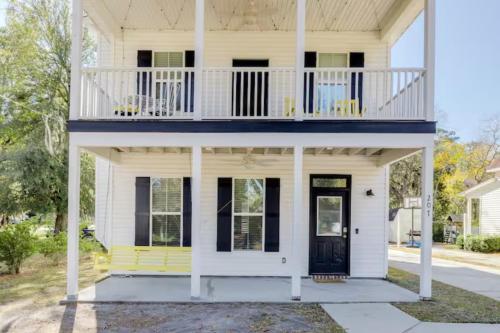 a white house with a porch and a balcony at Honey, I’m Home near Savannah - Seen on HGTV in Savannah