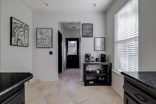 a kitchen with white walls and a black counter top at Honey, I’m Home near Savannah - Seen on HGTV in Savannah
