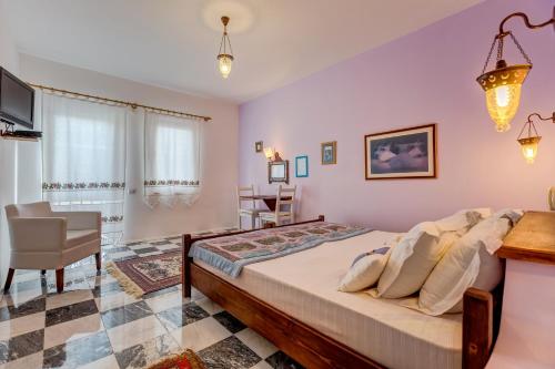 a bedroom with a large bed and a chair at Datca Villa Asina in Datca