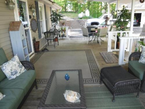 a screened porch with a couch and a table at serenity hill bed and breakfast in Brownsville
