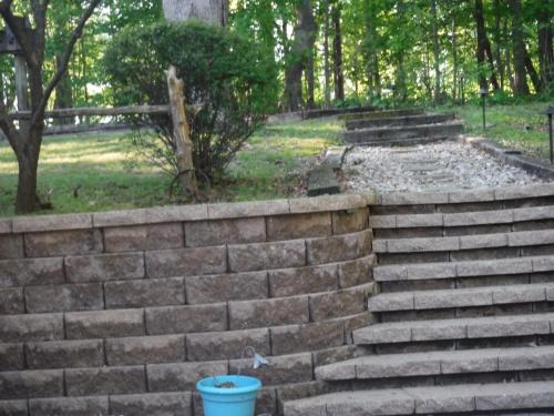 a set of stone steps with a blue bucket at serenity hill bed and breakfast in Brownsville