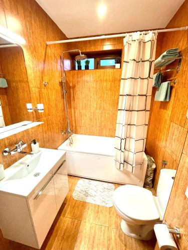 a bathroom with a toilet and a tub and a sink at Style Apartment in Sveti Vlas ( Kompleks Morski Far ) in Sveti Vlas