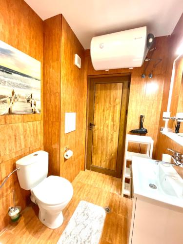 a bathroom with a toilet and a sink at Style Apartment in Sveti Vlas ( Kompleks Morski Far ) in Sveti Vlas