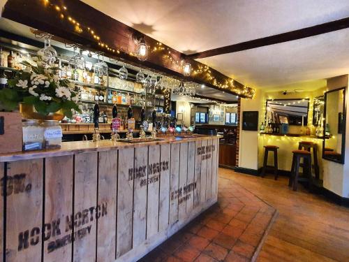 a bar with a wooden counter in a restaurant at The Crown Inn at Benson in Wallingford
