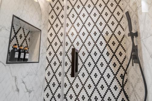 a bathroom with a shower with a mirror at The Georgetown House Inn in Washington