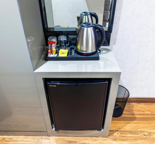 a table with a tea kettle on top of it at Dem Premium Hotel - Round Trip Airport Service - Istanbul International Airport in Arnavutköy