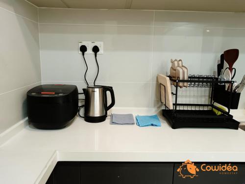 a kitchen counter with a coffee pot and other kitchen utensils at DangaBay in CountryGarden - Fantastic2 #Cowidea in Johor Bahru