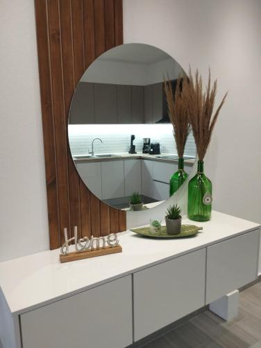 a bathroom with a sink and a mirror at GRAMMENOS HOUSE in Agios Nikolaos