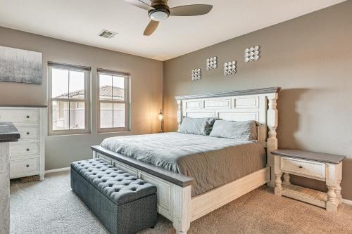 a bedroom with a bed and a ceiling fan at Goodyear Home with Private Patio and Golf Course View in Goodyear