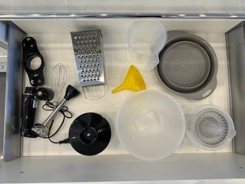a drawer with various kitchen utensils in it at Bogyó Family Land Budapest in Budapest