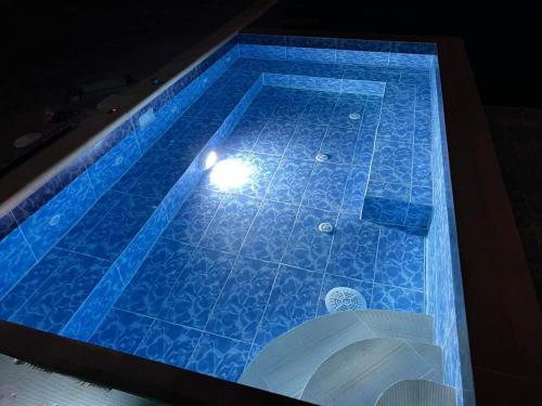a swimming pool with a light in the middle at Бонита Хотел Спа in Strelcha