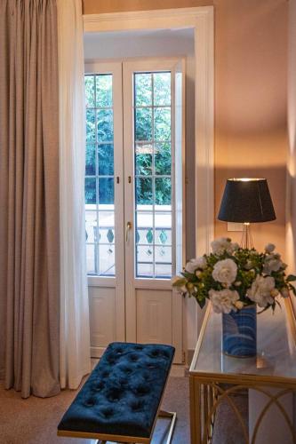 a living room with a table with a vase of flowers on it at Palazzo Bove 2 - Villa Dagmar in Galatone