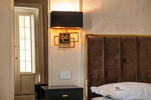 a bedroom with a bed with a headboard and a lamp at Palazzo Bove 2 - Villa Dagmar in Galatone