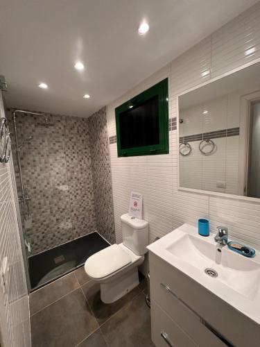 a bathroom with a toilet and a sink and a shower at Paradise Club L28 & L29 in Puerto del Carmen