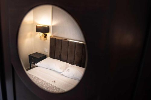 a mirror reflection of a bed in a room at Palazzo Bove 2 - Villa Dagmar in Galatone