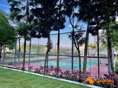 a fence next to a swimming pool with palm trees at DangaBay in CountryGarden - Fantastic2 #Cowidea in Johor Bahru