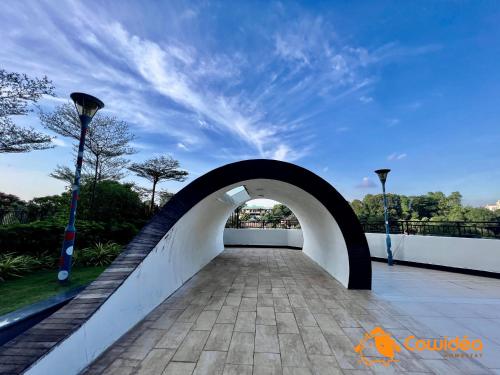 a bridge over a walkway with a blue sky at DangaBay in CountryGarden - Fantastic2 #Cowidea in Johor Bahru