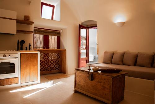 a living room with a couch and a table at Approxi Cave: 2-Bedroom Retreat in Éxo Goniá