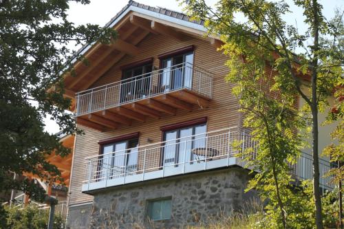 a building with a balcony on the side of it at Chalet Zauberberg in Zwiesel