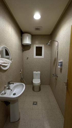 a bathroom with a toilet and a sink at شقة مفروشة وسط الرياض in Riyadh