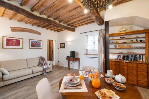 a living room with a table and a couch at Borgo dei Fondi in Siena